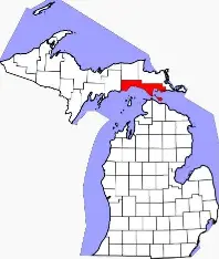 Image of the upper and lower peninsula of Michigan with counties outlined and a red highlight on Mackinac county.