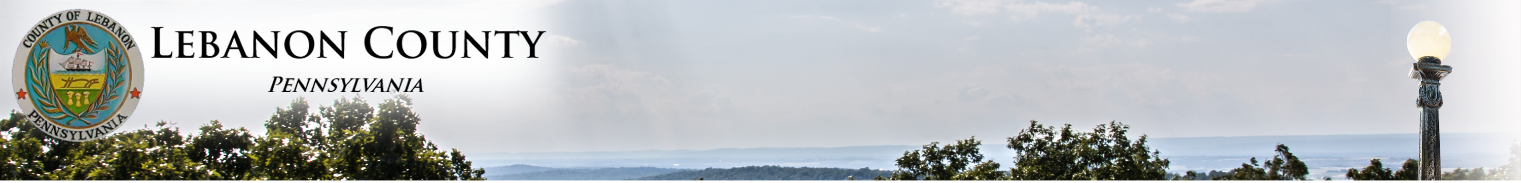 A banner featuring the seal of Lebanon County, Pennsylvania, with a scenic view of hills and trees in the background.