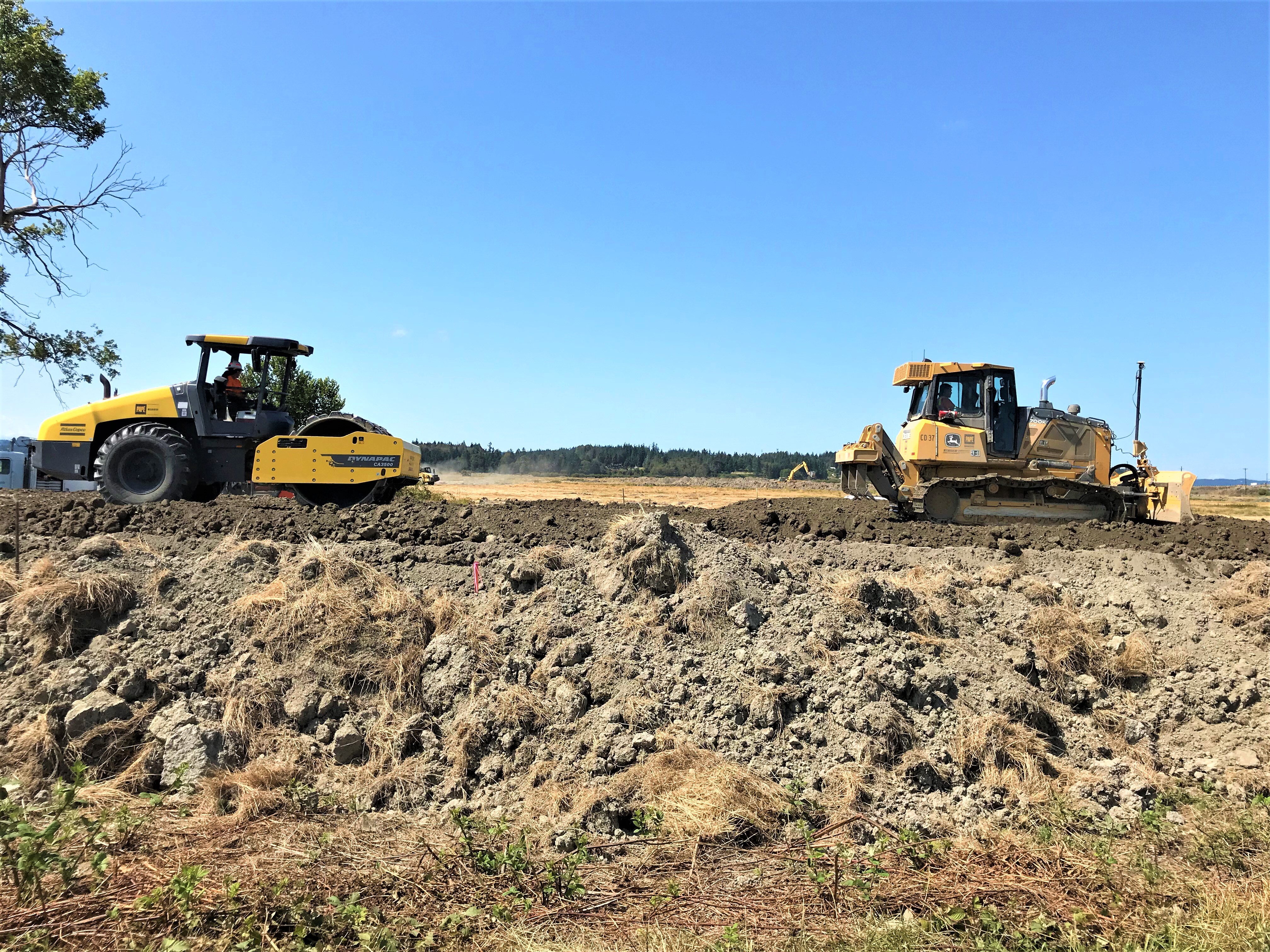 Heavy equipment preparing a construction site.